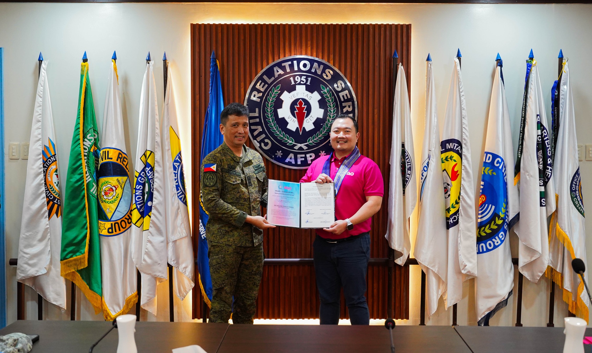 Major General Ramon P Zagala PA, Commander of the AFP's Civil Relations Service, and Francis Chua, head of 2GO Travel, respectively, signed the agreement to officially launch the partnership between the AFP and 2GO. Photo grab from AFP Radio DWDD Facebook page.